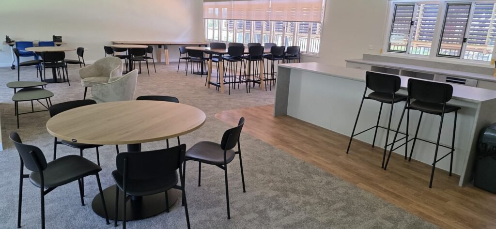 Assembled meeting tables, stools and chairs in an office breakout area