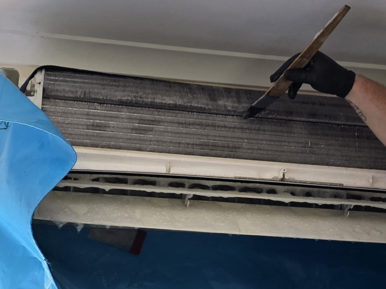 Split system coil being cleaned with a catch bag fitted