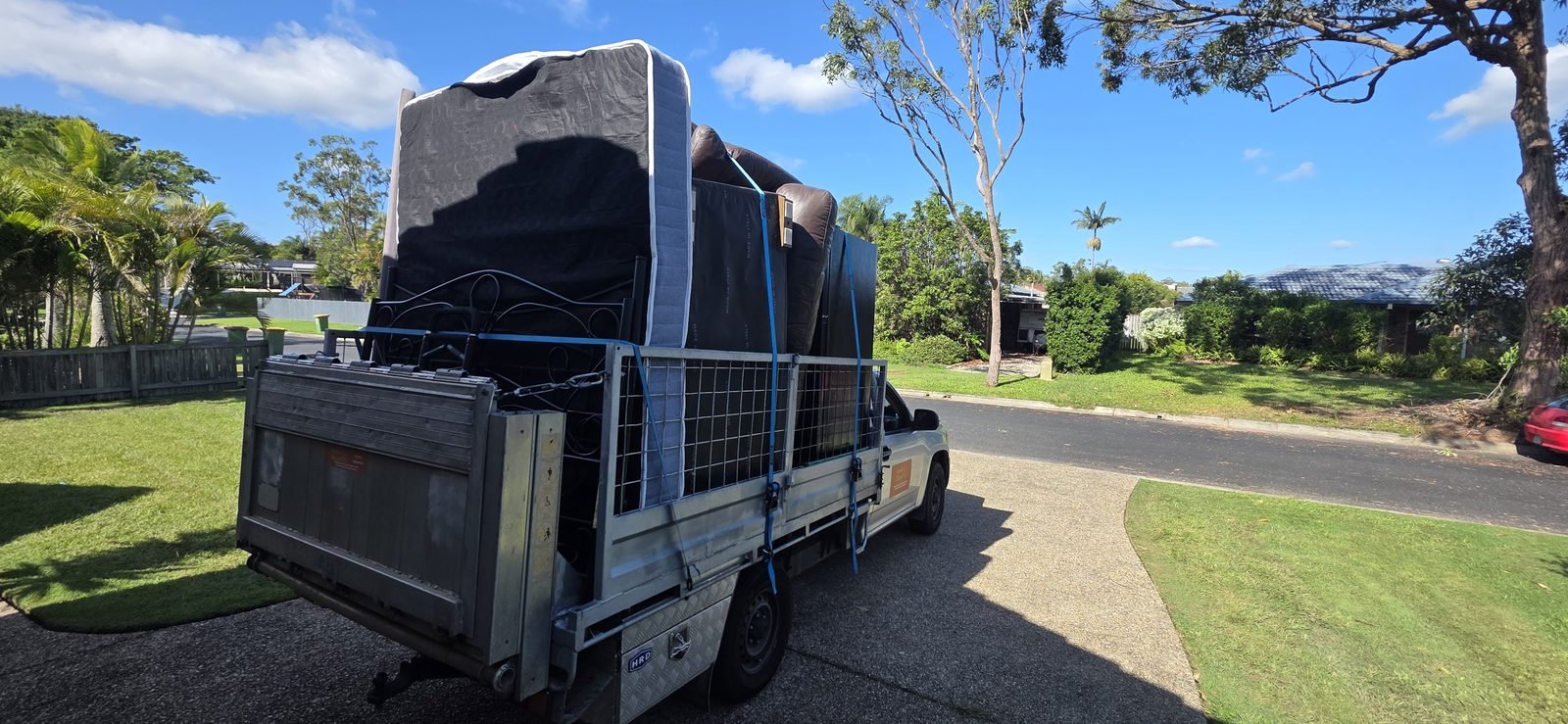 Mattress and household furniture strapped in the caged ute